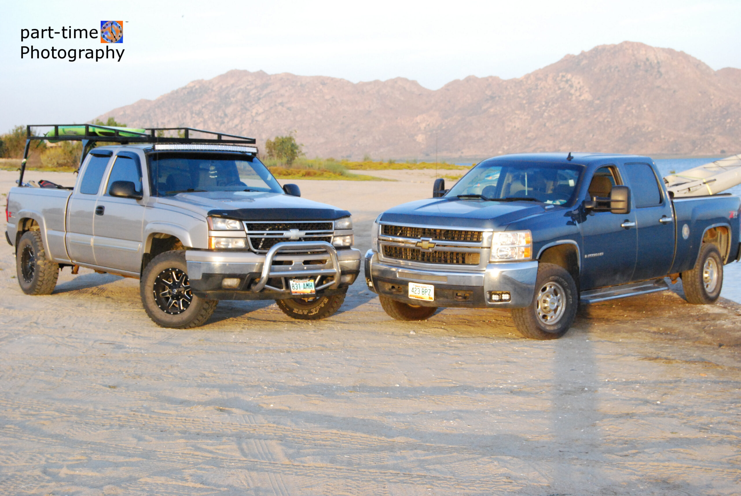 trucks on the beach in california at sunset by part time photography